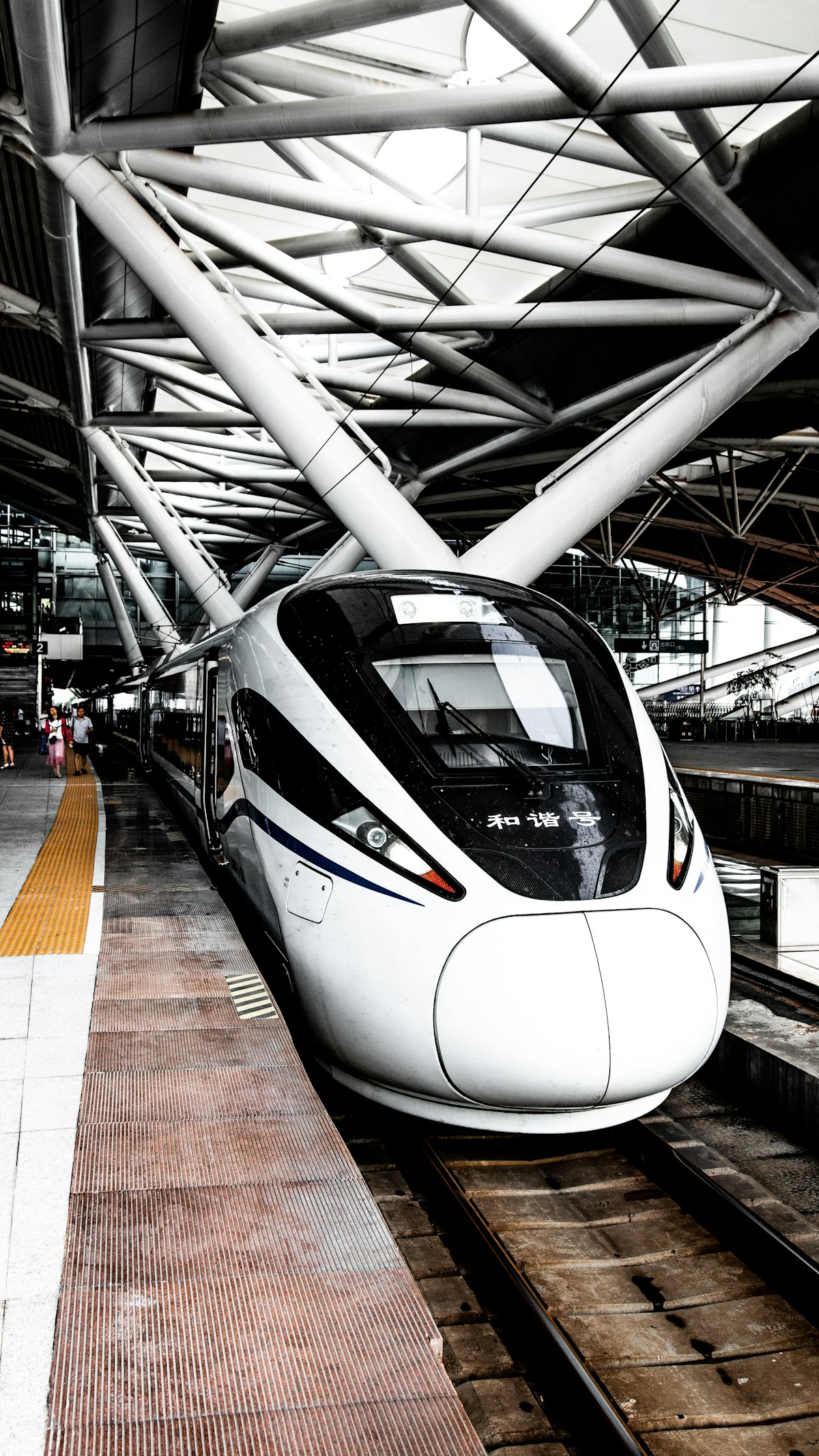 A sleek China high-speed train at a modern station platform — the backbone of multi-week travel across China's vast rail network