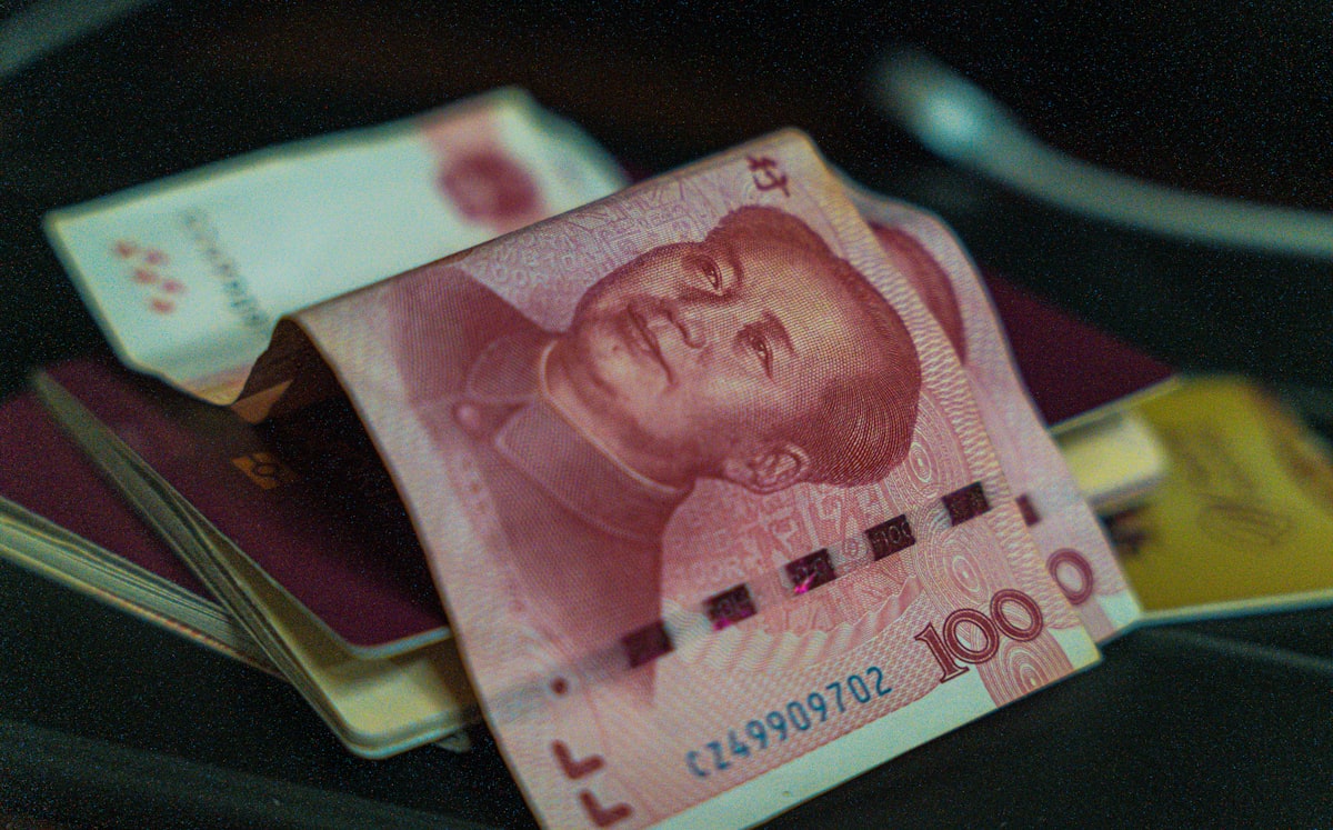 Chinese yuan banknotes on top of passports