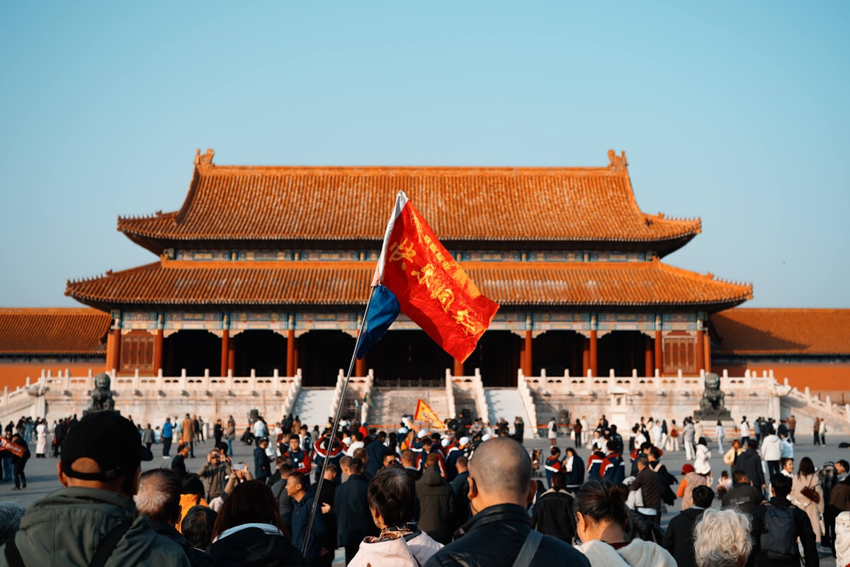 Crowd gathered in front of a large traditional Chinese building during Golden Week